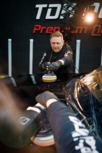 Darius, from TDK Detailing, machine polishing a car